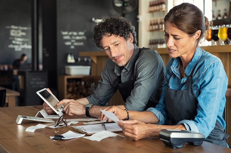 Small business owners reviewing tax documents