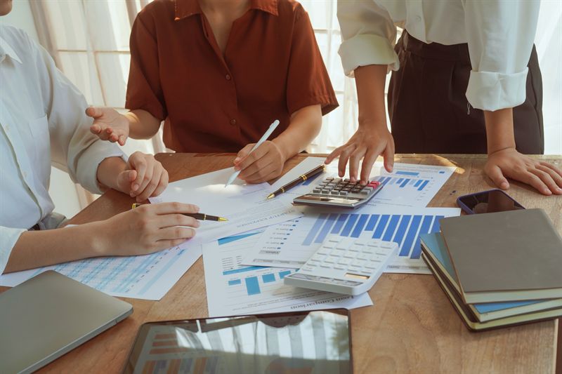 Reviewing financial reports with calculators